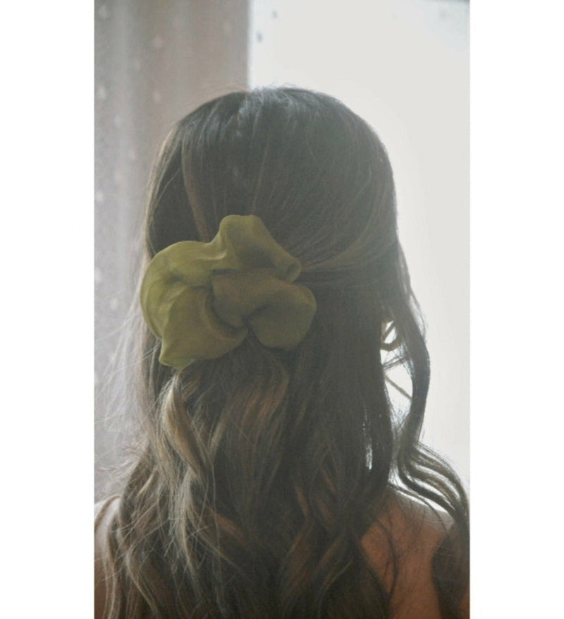 Matcha silk scrunchie in chiffon in a girls hair 
