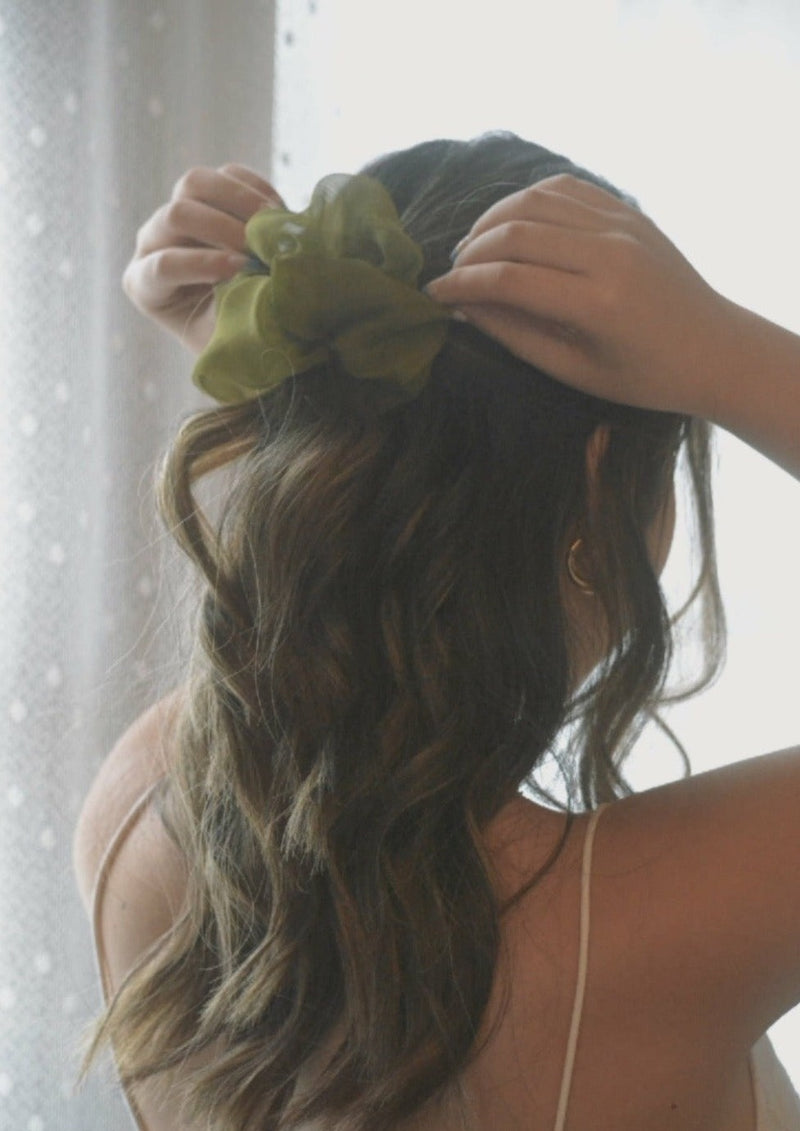 matcha silk scrunchie in chiffon in a girls hair 